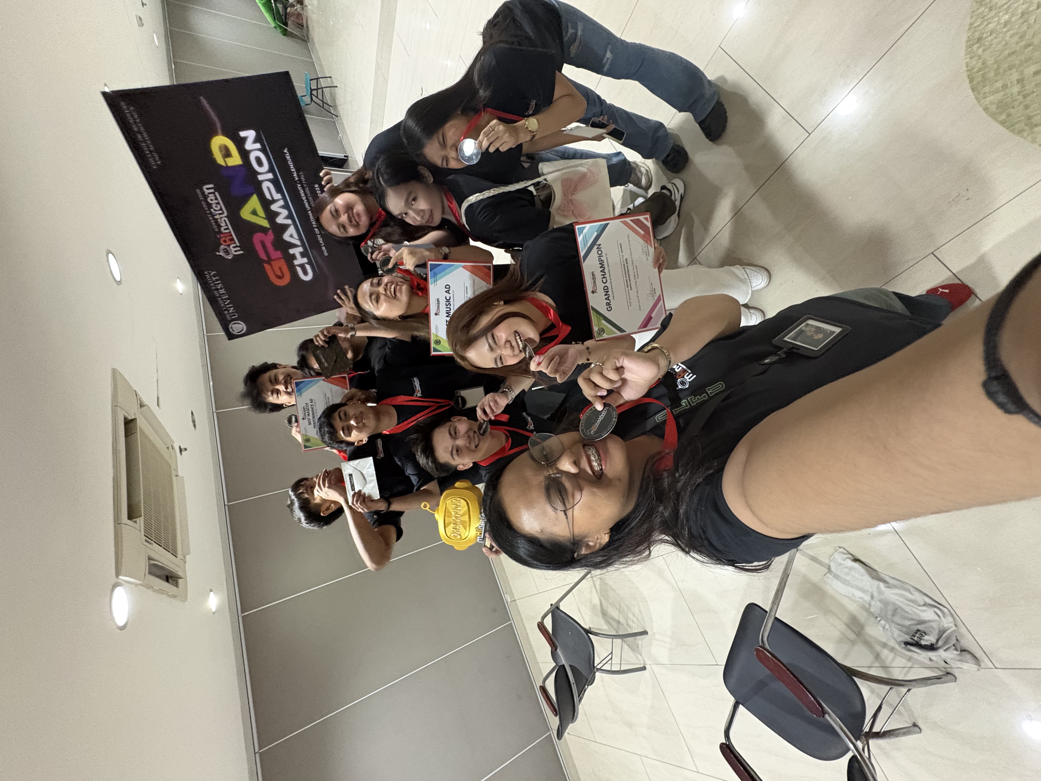 Team selfie with medals and grand champion certificate